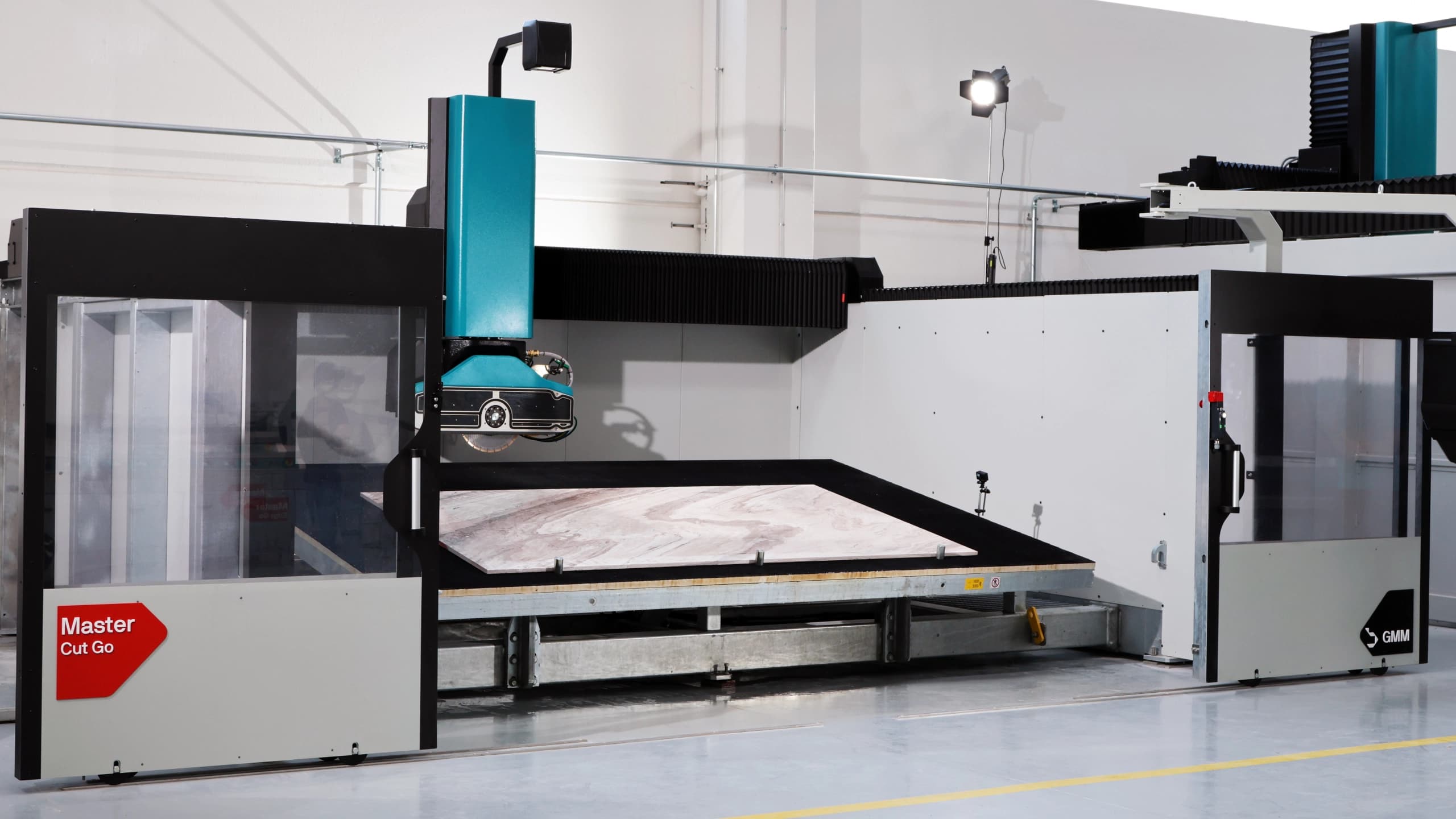 CNC bridge saw cutting a slab on the workshop cutting table